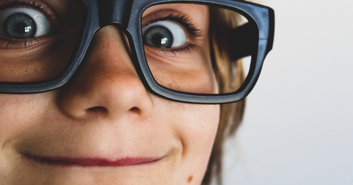 close up of smiling kid with glasses