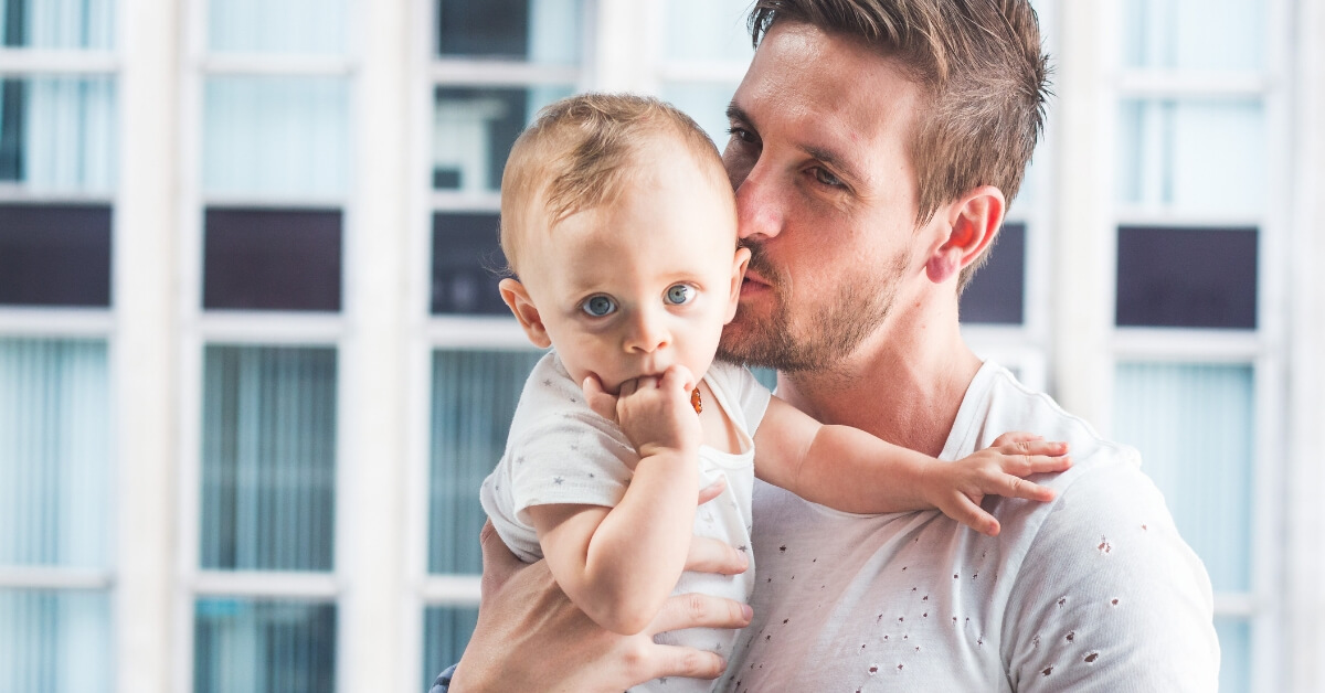 dad kissing baby boy