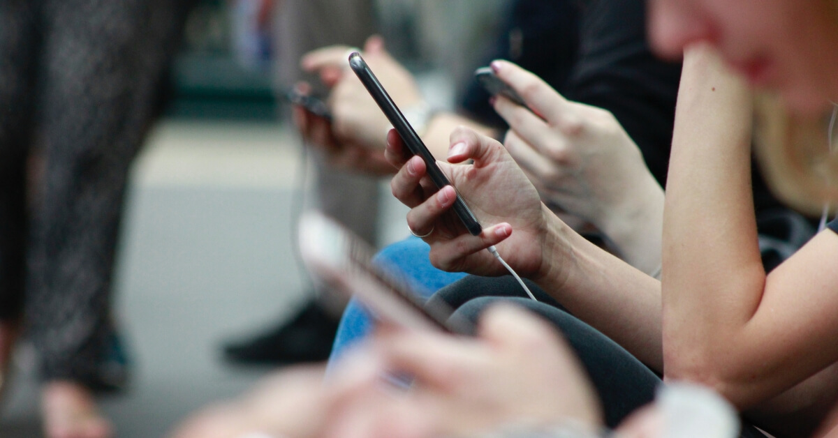 a person's hand holding a phone in focus