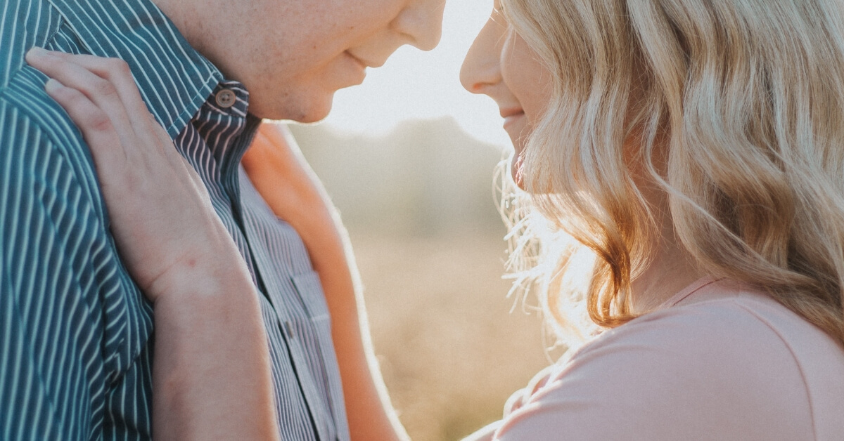 man and woman touching heads facing each other