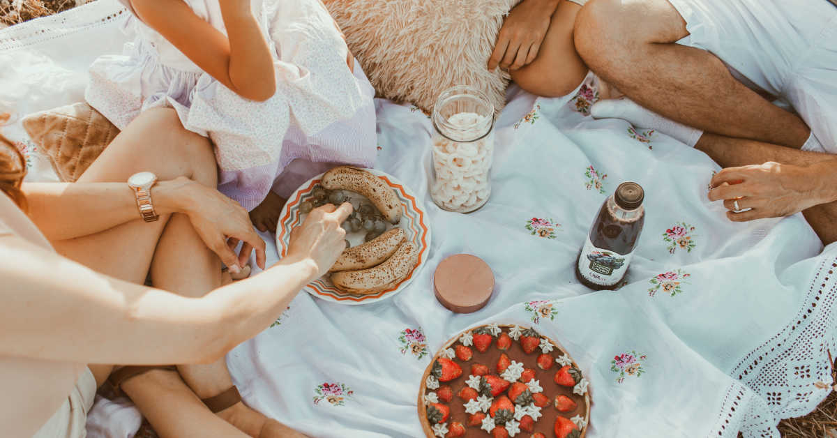 Family having a picnic on a white rug