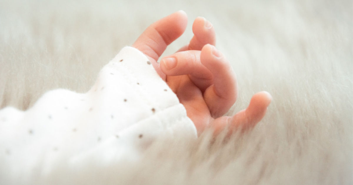 Baby hand on fluffy blanket