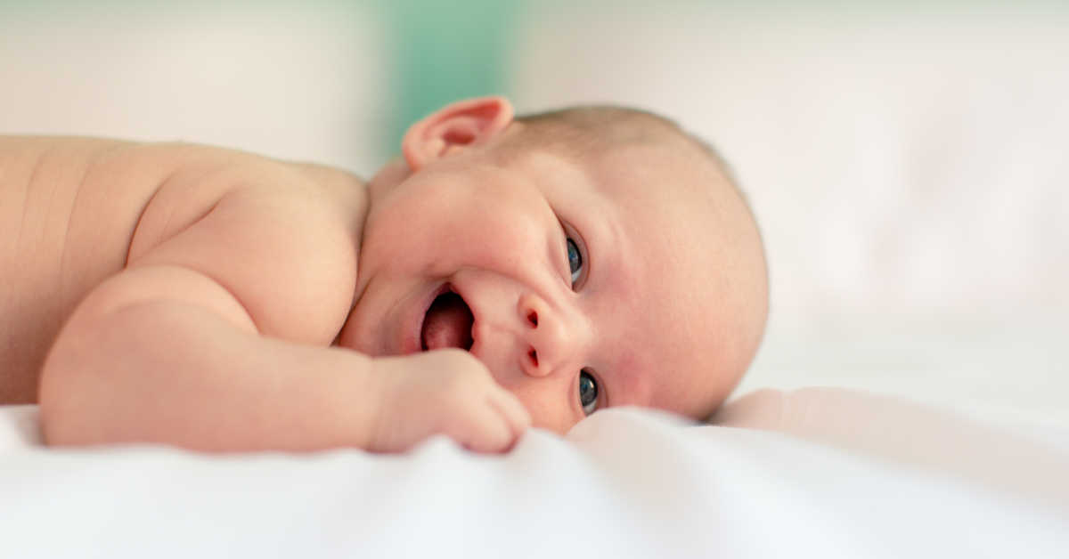 Baby laying on tummy smiling