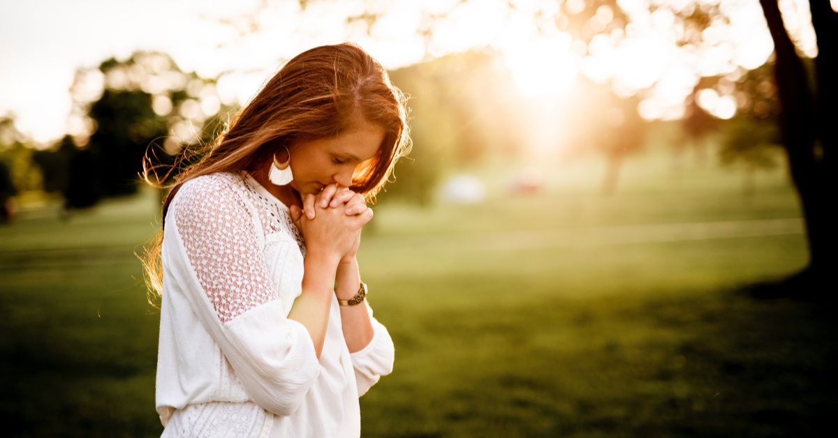 Woman praying in feild