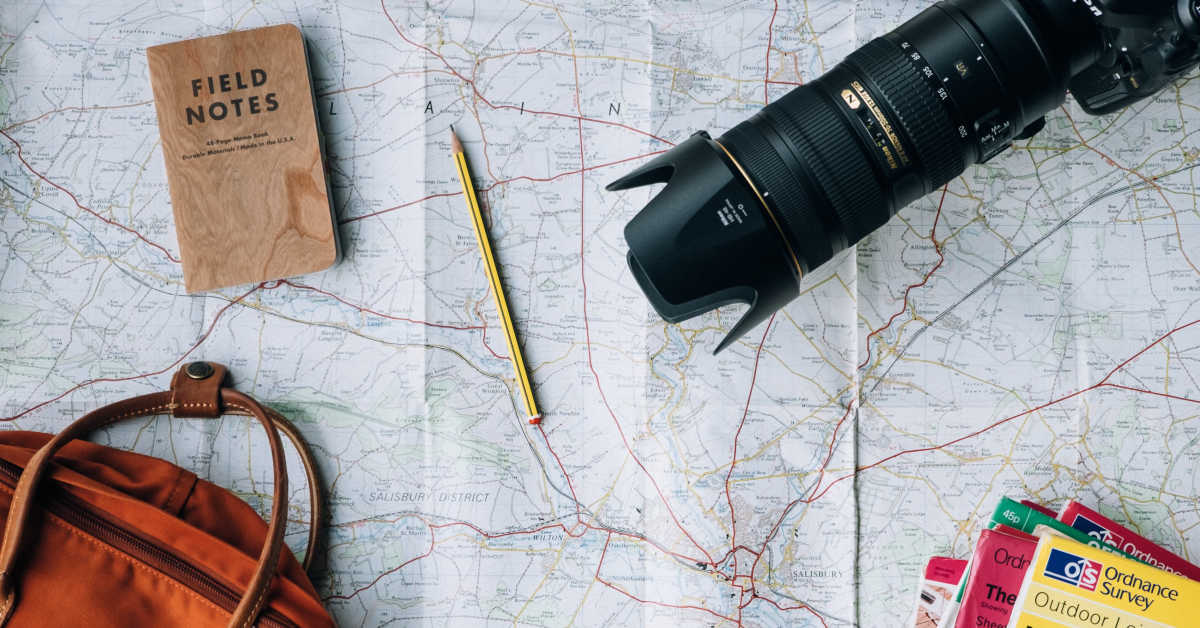 Map, bag, and camera flat lay