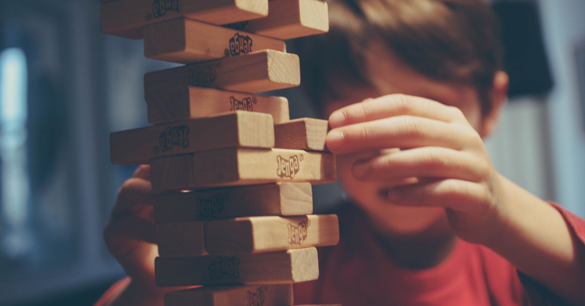 boy playing jenga