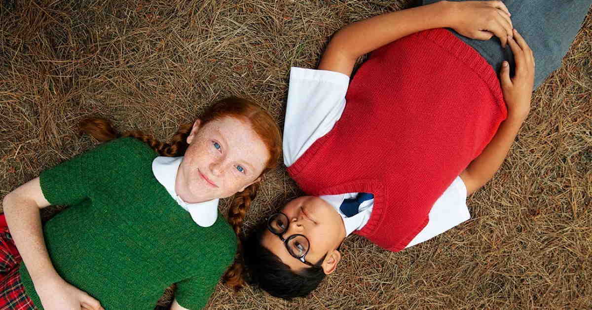 characters from the movie lying on the grass looking up at camera