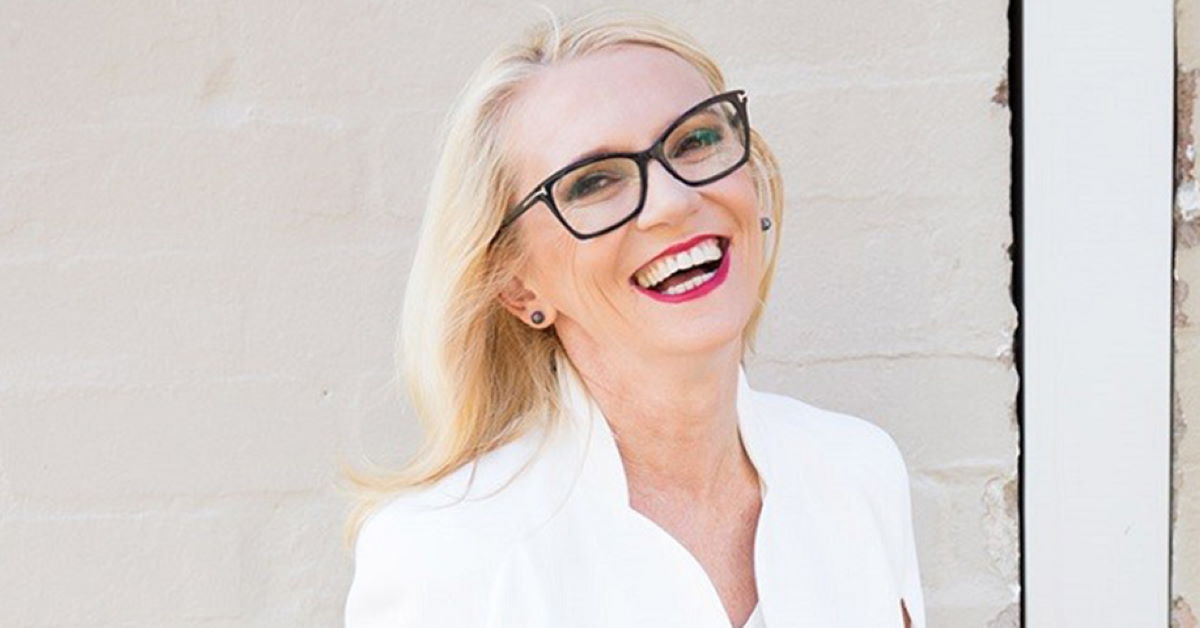 Dr Suzy Green wearing dark rimmed glasses and smiling at the camera