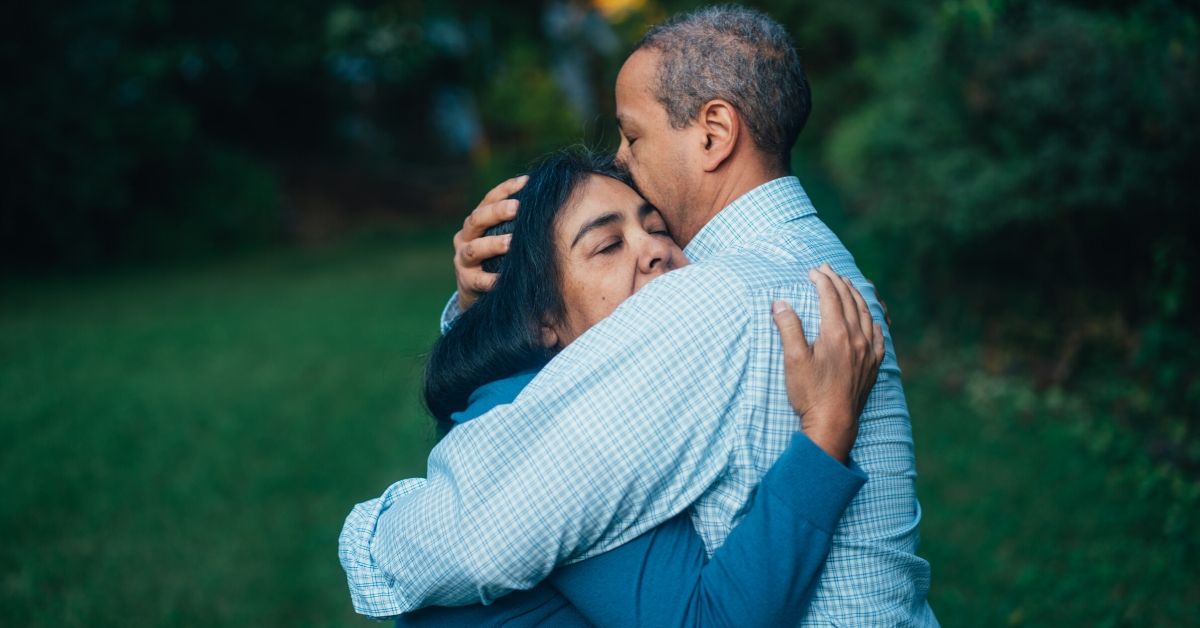 photo of a man hugging a woman