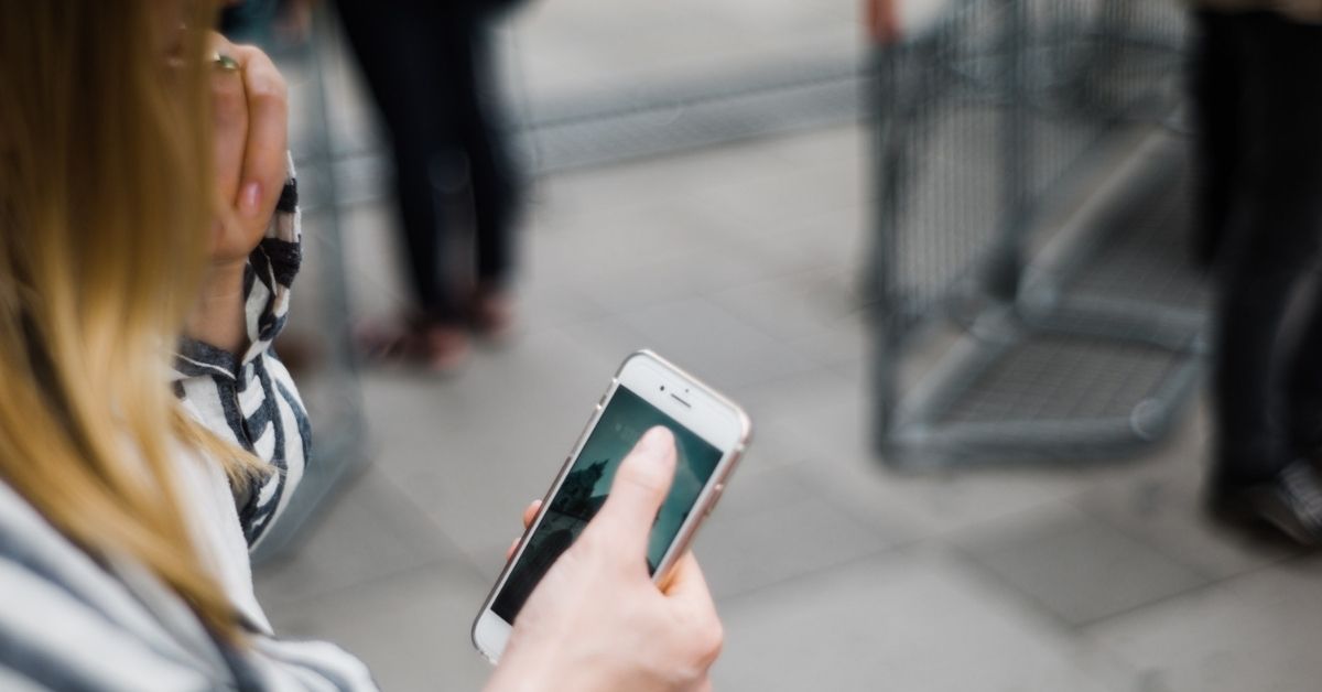 girl looking down at phone