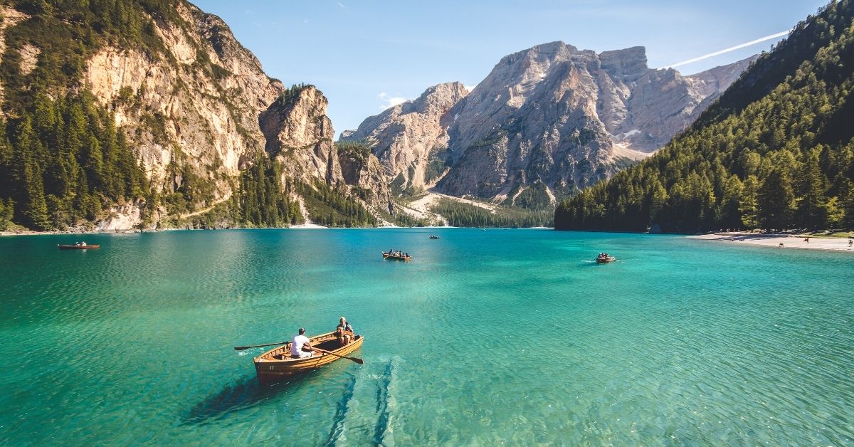 boat on a clear lake with mountains in the background