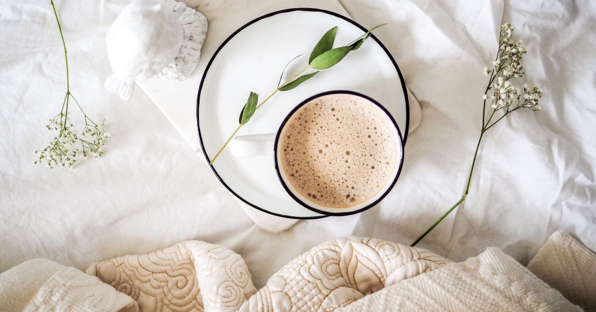 coffee on a plate on a bed