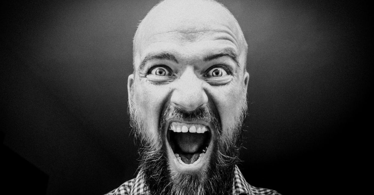 a black and white photo of man yelling