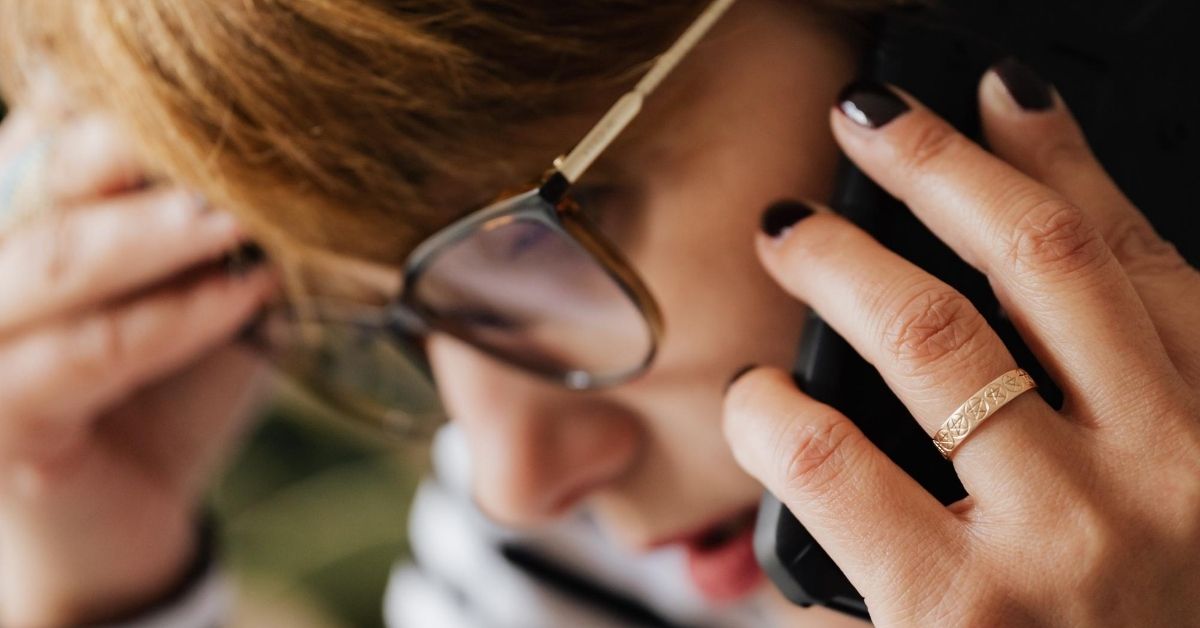 woman looking deflated on the phone