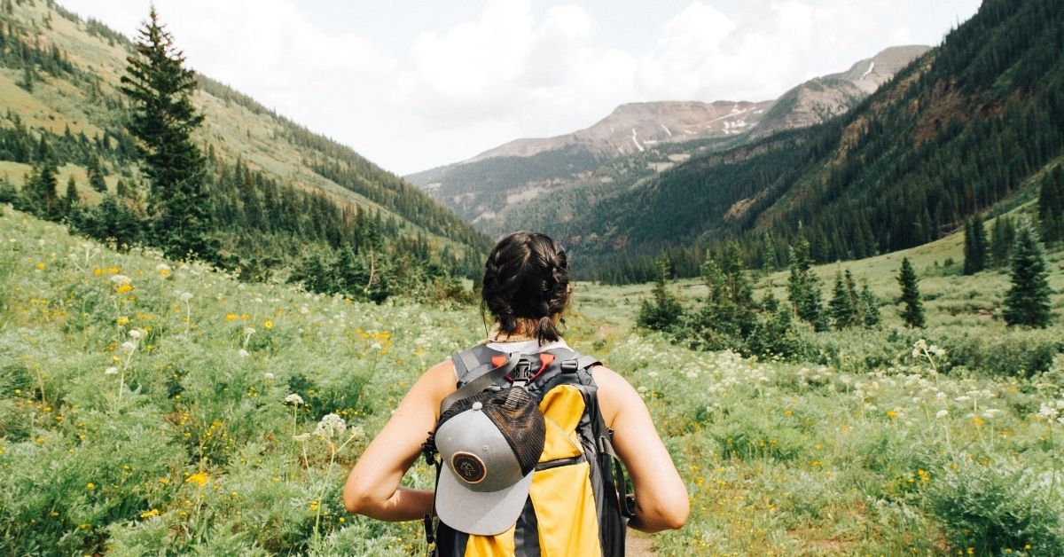 man hiking through a valley