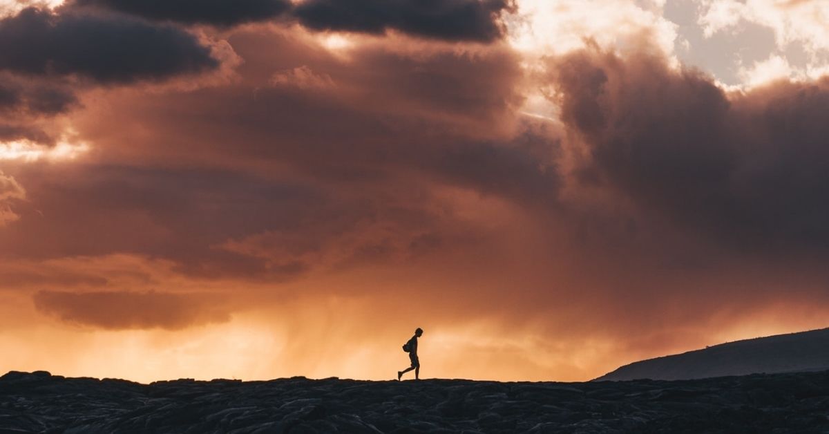 silhouette of a man walking alone