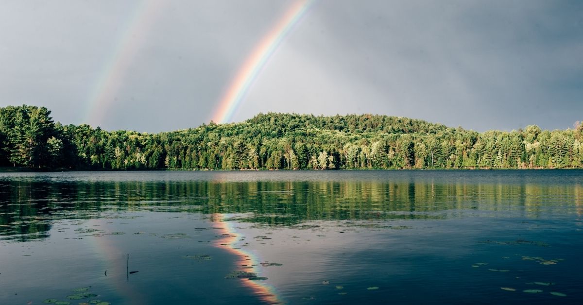 rainbow over still water