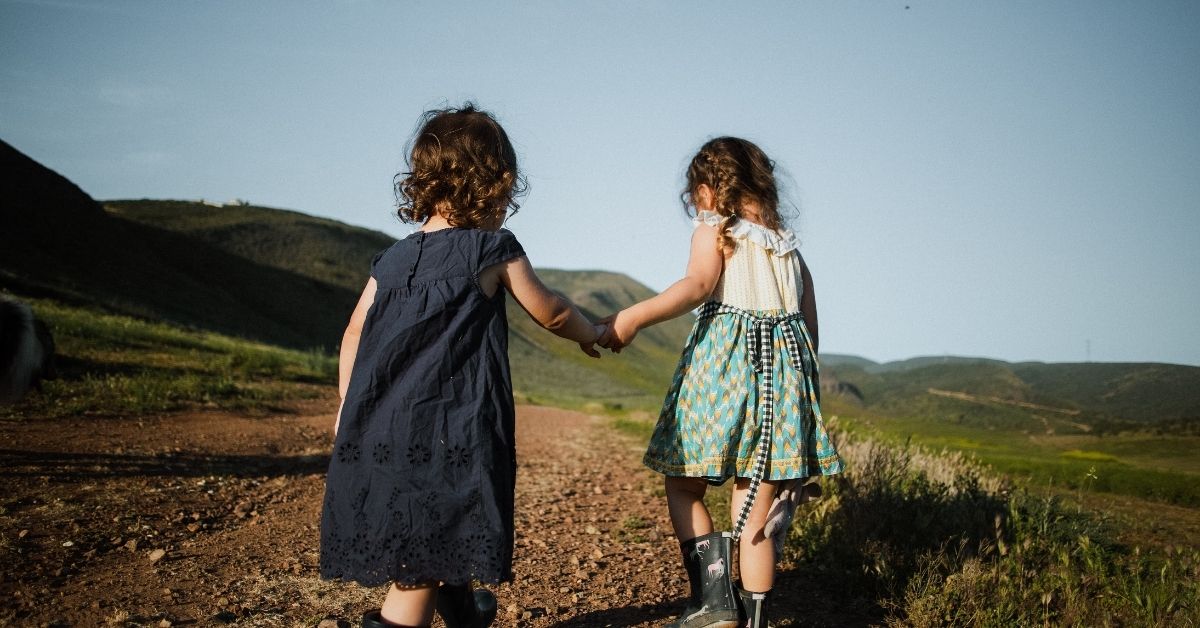 young girls holding hands