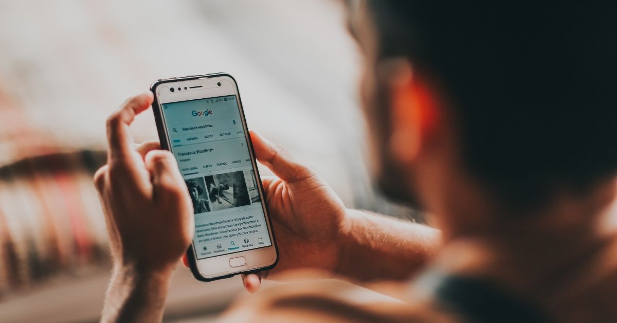 man reading news on his phone