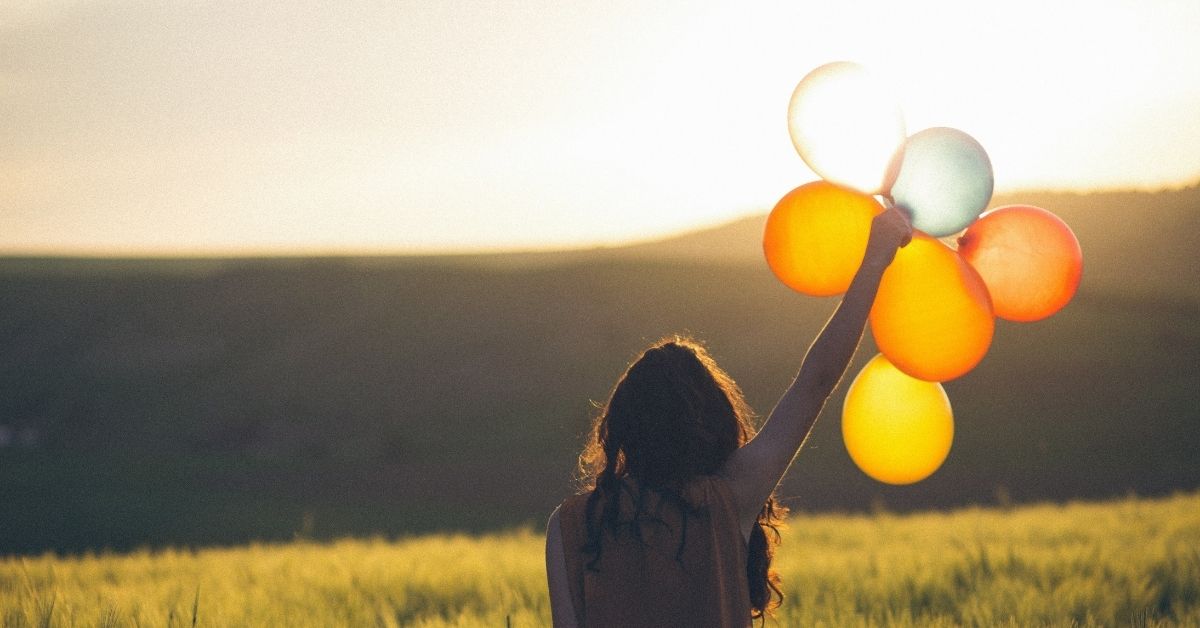 woman holding balloons