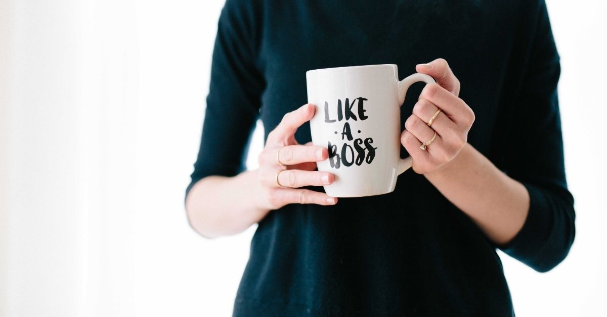 woman holding a like a boss mug