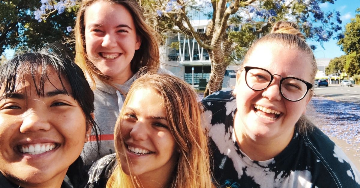 four girl friends smiling in a selfie