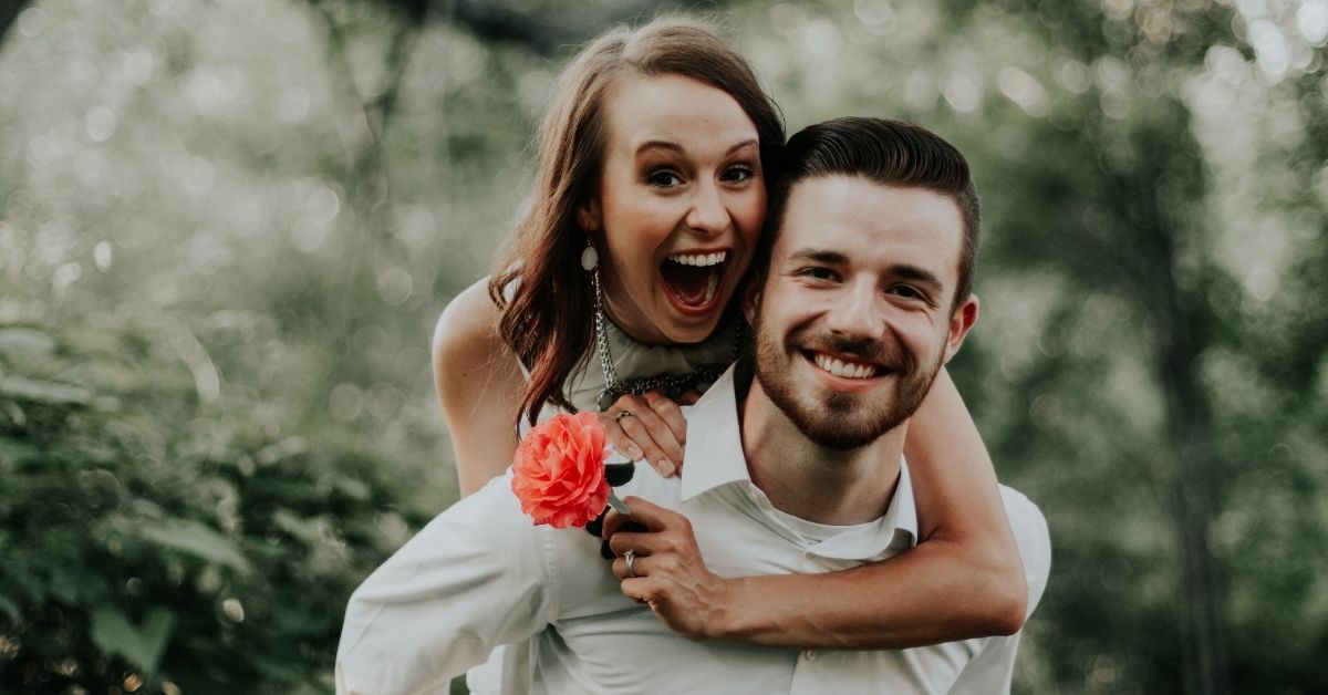 a happy married couple smiling at the camera