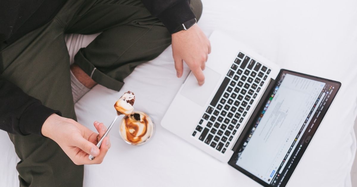 a person snacking while working on the computer