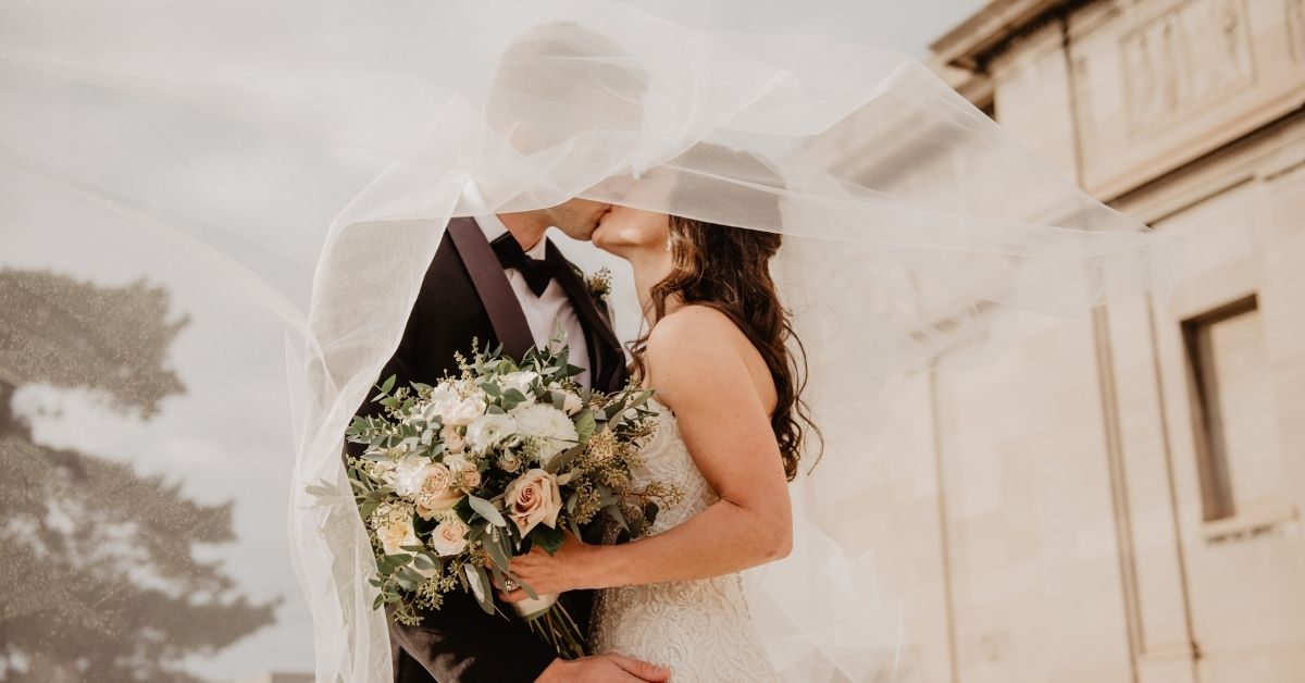 married couple kissing on their wedding day