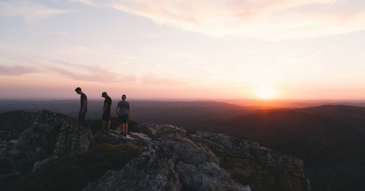 a group of people standing on a mountaintop