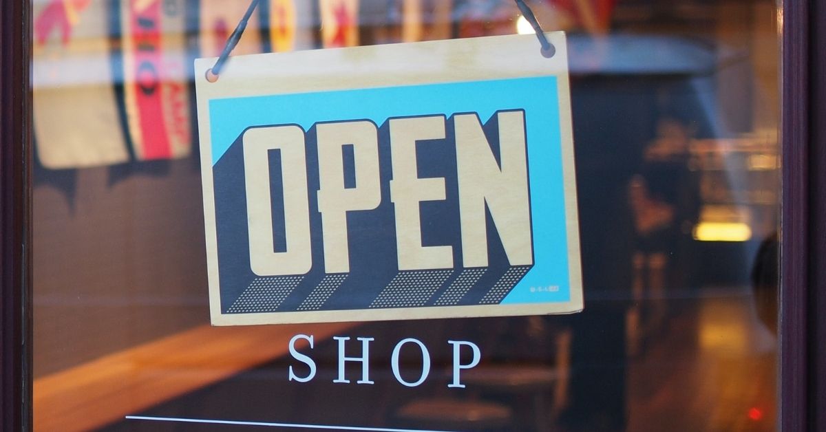 an open sign on a shop front