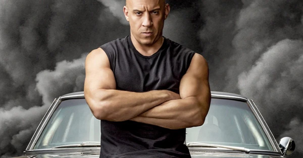 vin diesel posing in front of a car