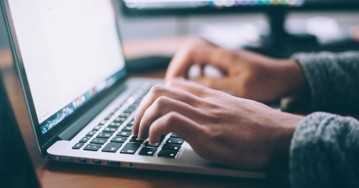 hands typing on a laptop