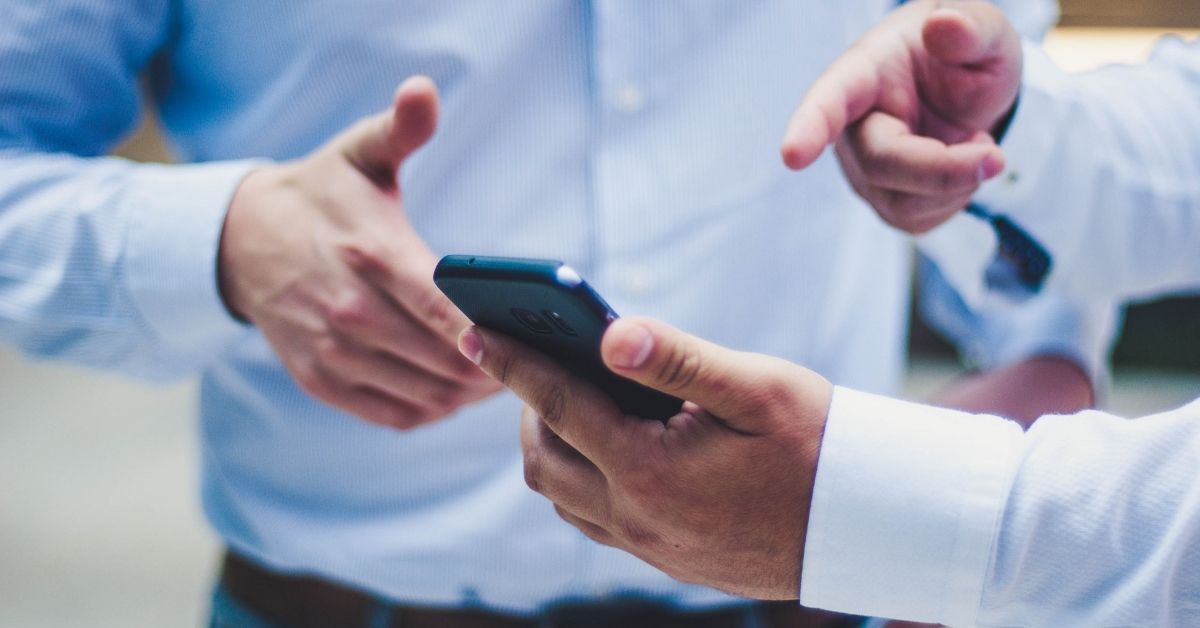 men looking at a phone