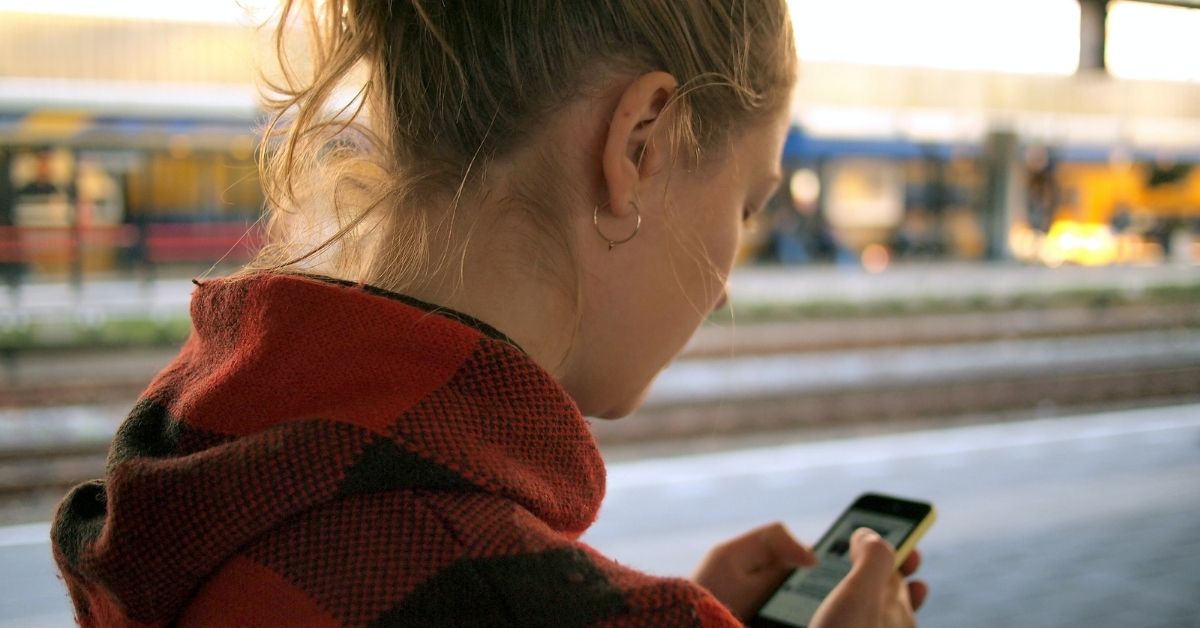 a woman looking down at her phone