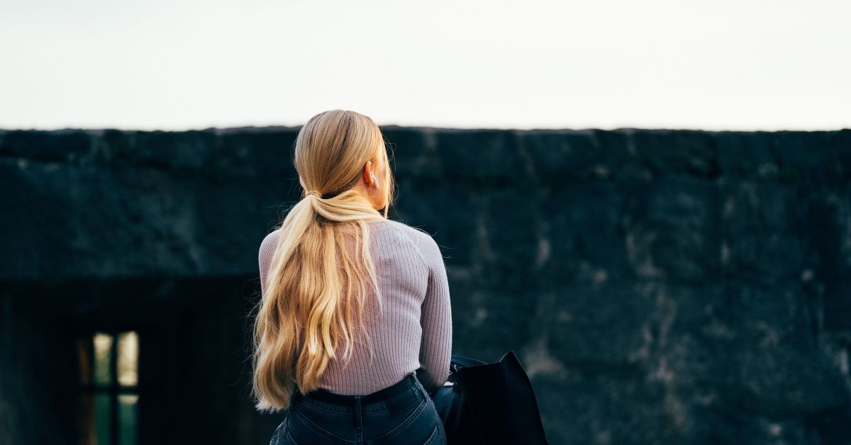 girl sitting on a wall