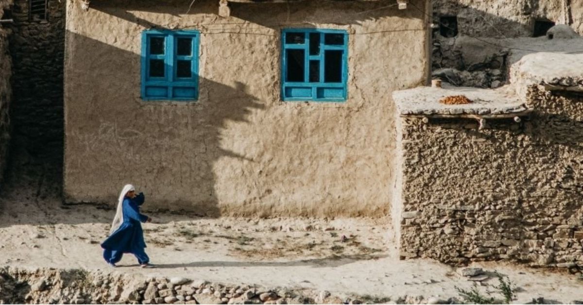 a woman in a black burka walking in the day