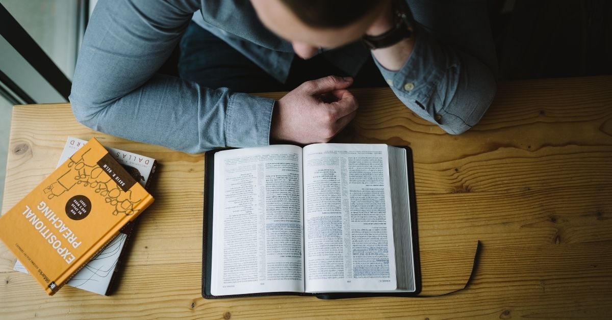 man reading a bible