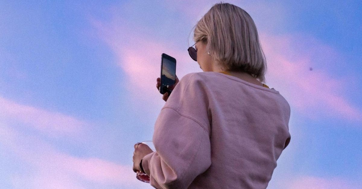 Young Millennial Woman taking selfie on phone