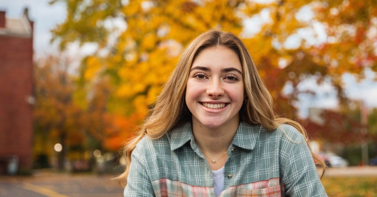 a young girl smiling at the camera