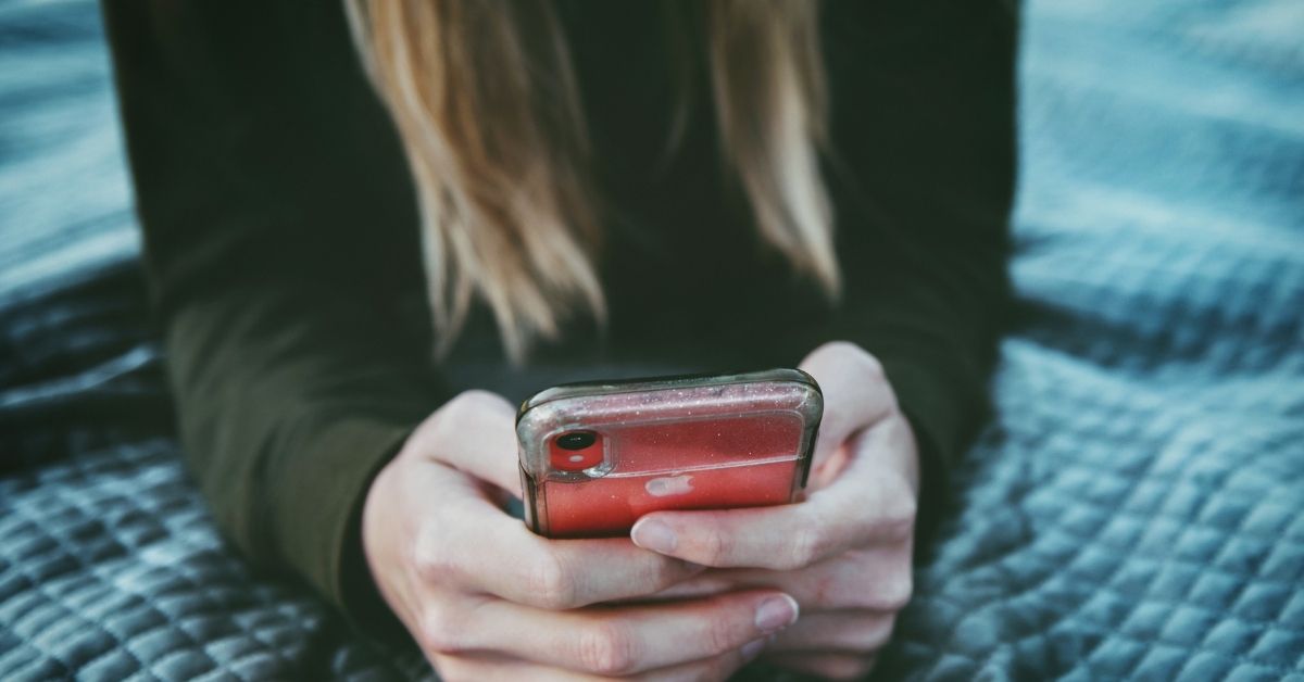 person looking down at phone