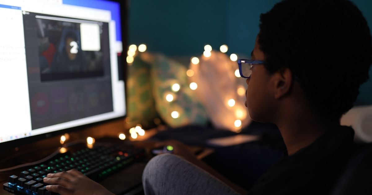 A kid playing on his computer