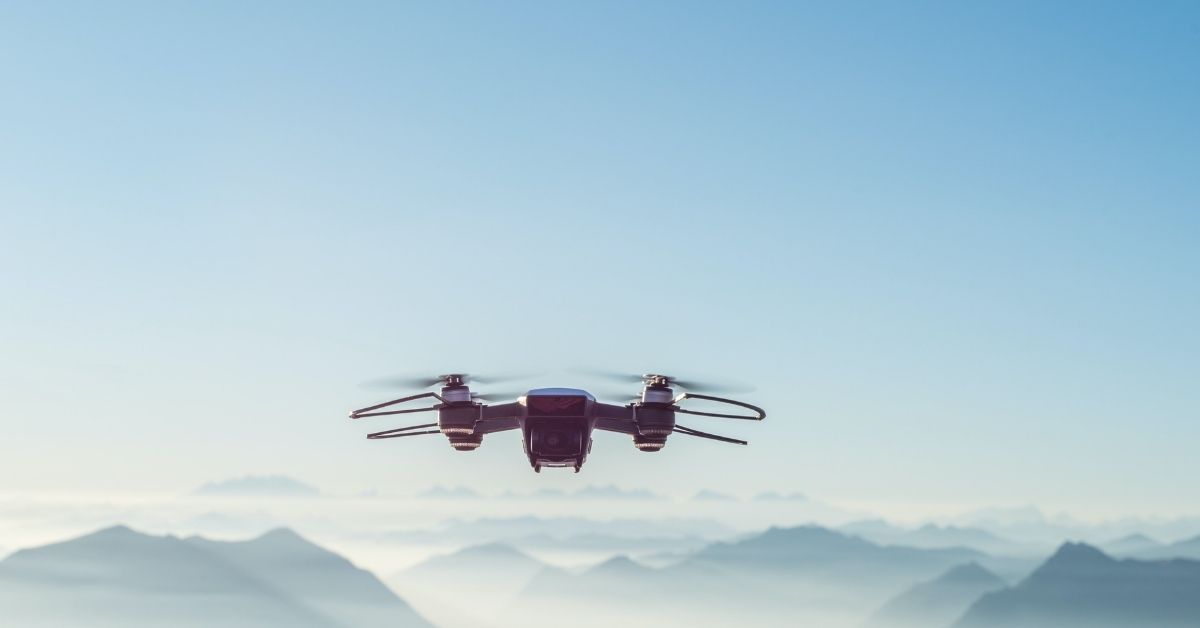 Drone flying in blue sky by Alessio Soggetti