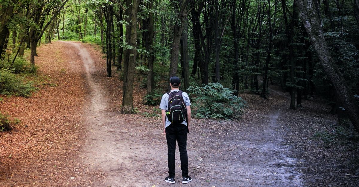 Man standing at a crossroads