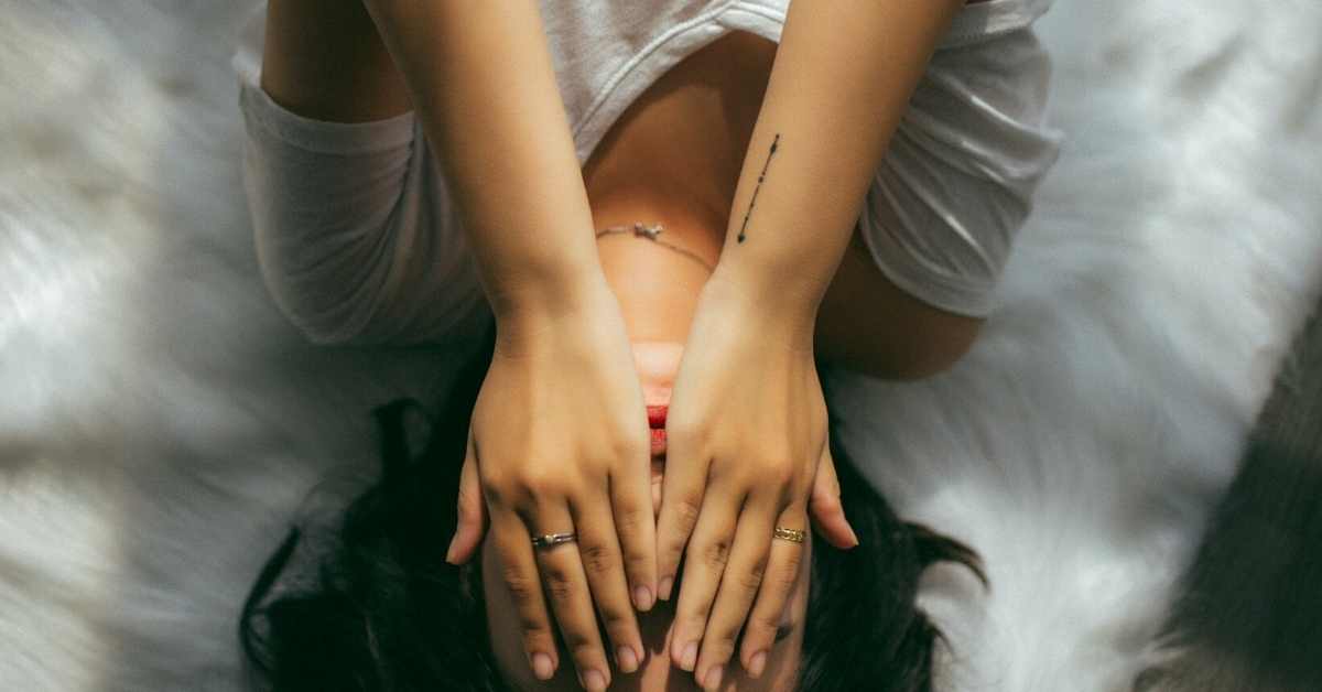 Woman lying on bed stressed